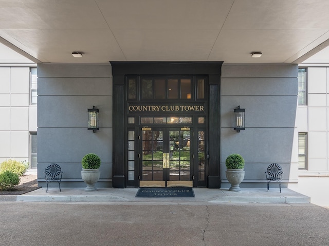 property entrance with covered porch and french doors
