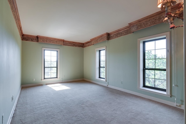 carpeted spare room with ornamental molding