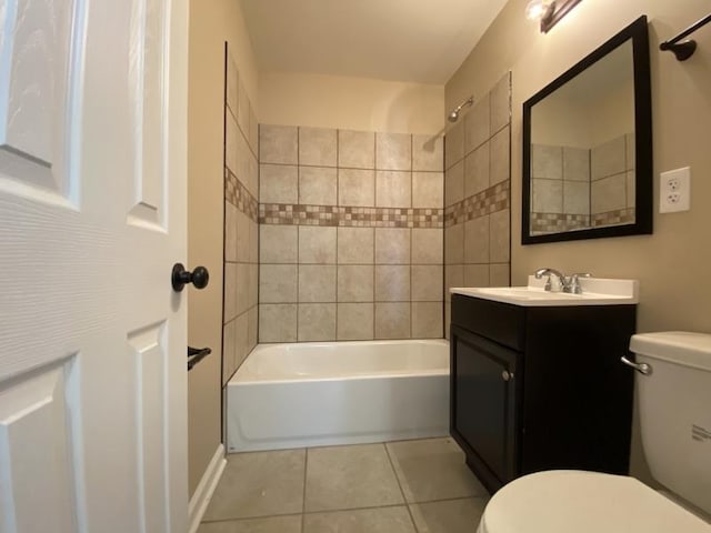 full bathroom featuring tiled shower / bath, vanity, toilet, and tile patterned floors