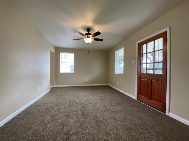 carpeted foyer entrance with ceiling fan