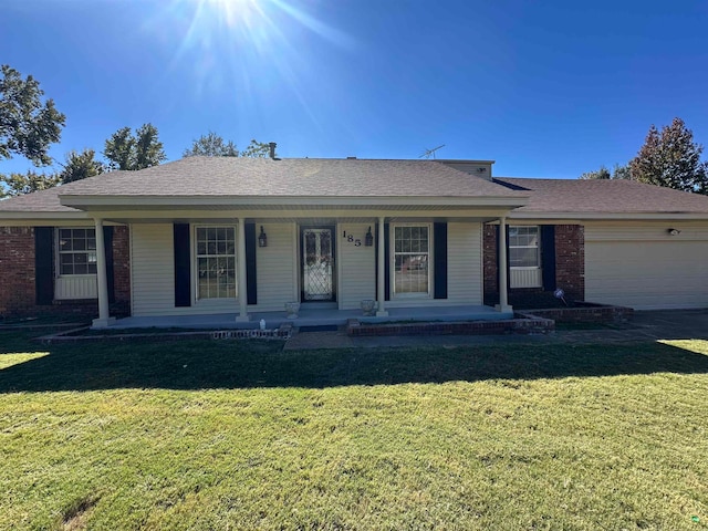 ranch-style home with a front yard, a porch, and a garage