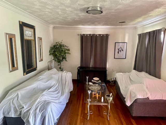 bedroom with crown molding, a textured ceiling, and dark hardwood / wood-style flooring