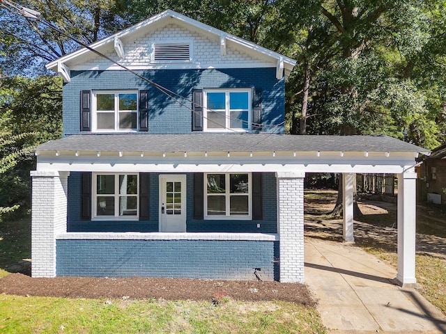 view of front of house with covered porch and a carport