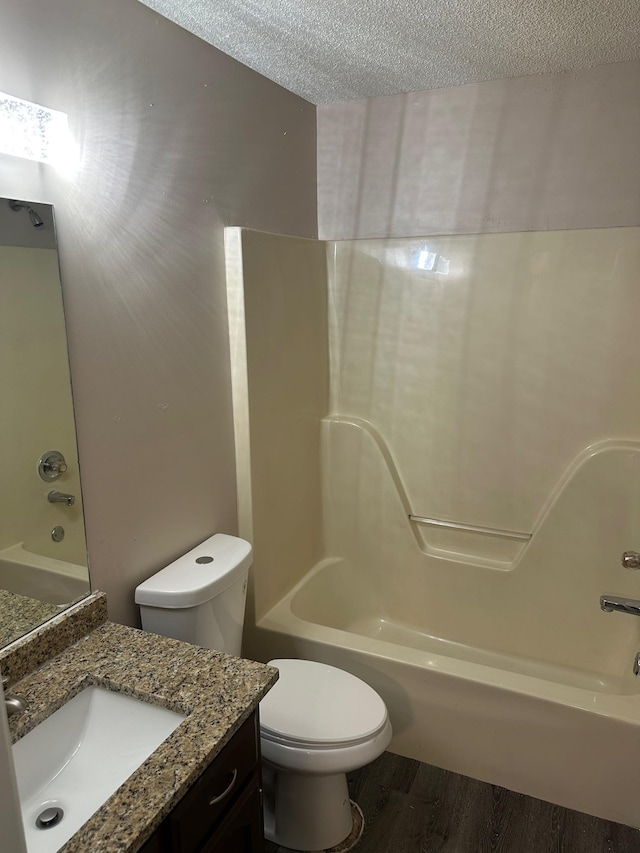 full bathroom featuring shower / bath combination, a textured ceiling, toilet, vanity, and hardwood / wood-style flooring