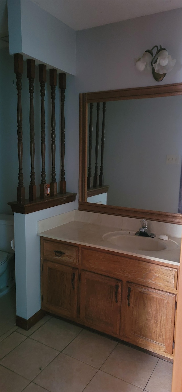 bathroom featuring vanity, toilet, and tile patterned floors