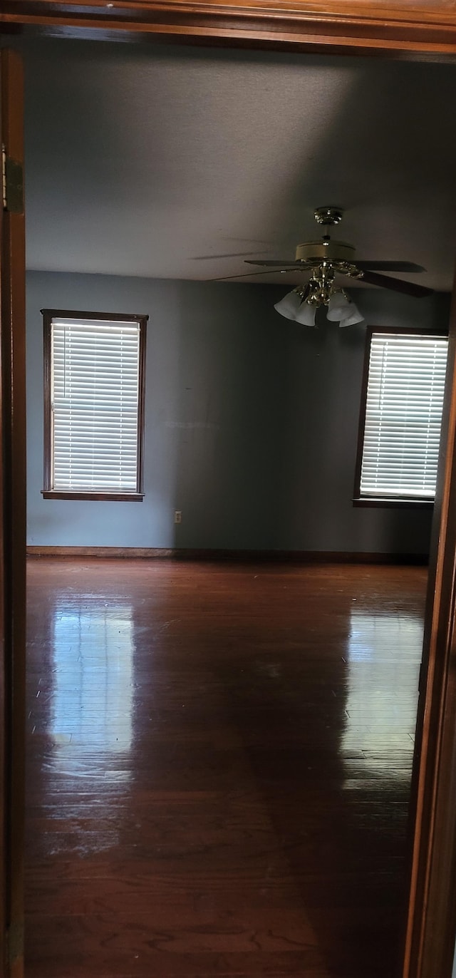 empty room featuring ceiling fan and hardwood / wood-style flooring