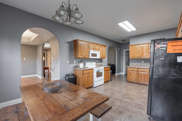 kitchen featuring an inviting chandelier and white appliances