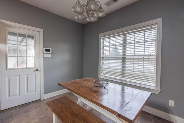 unfurnished dining area with tile patterned flooring and a notable chandelier