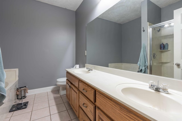 full bathroom with tile patterned flooring, vanity, a textured ceiling, shower with separate bathtub, and toilet