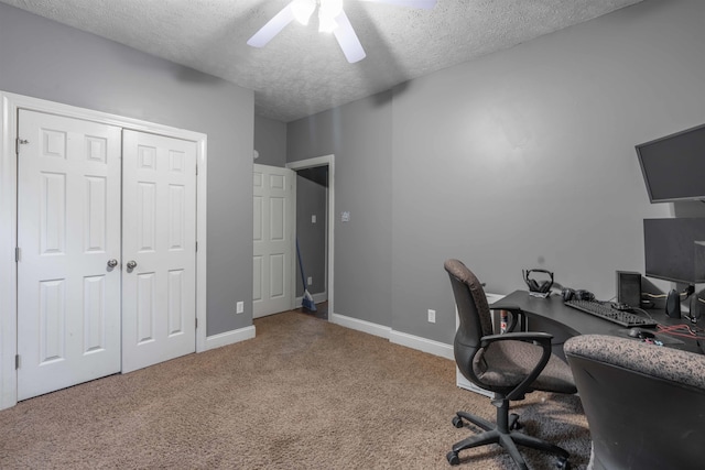 home office with ceiling fan, carpet floors, and a textured ceiling