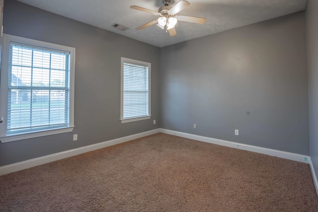 empty room featuring ceiling fan and carpet floors