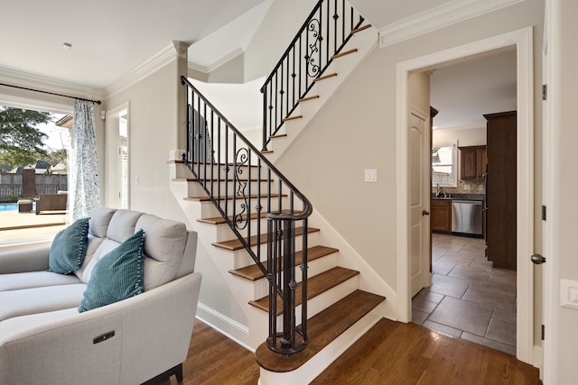 stairs featuring crown molding and hardwood / wood-style floors