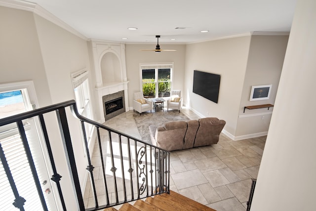 living room featuring ornamental molding, light wood-type flooring, and ceiling fan