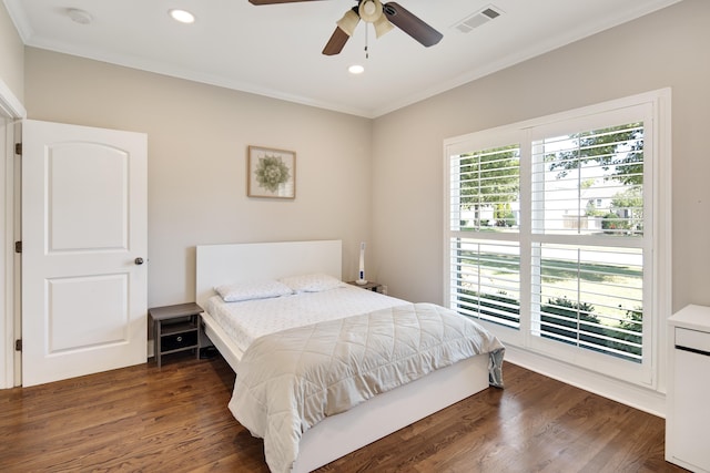 bedroom with ornamental molding, dark hardwood / wood-style floors, and ceiling fan