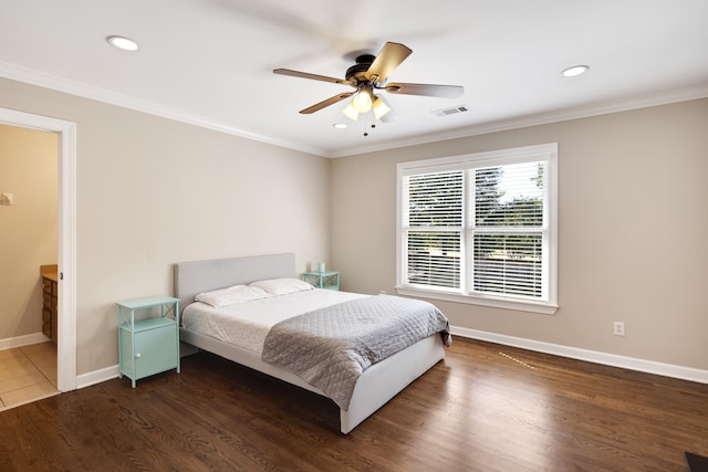 bedroom with ornamental molding, dark hardwood / wood-style floors, ensuite bathroom, and ceiling fan