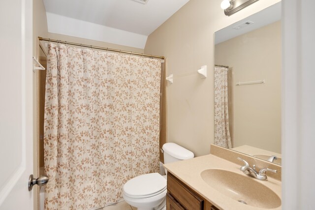 bathroom featuring toilet, a shower with curtain, and vanity