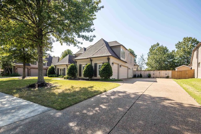 view of front facade with a front yard and a garage