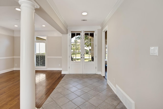 entryway with ornamental molding, decorative columns, light hardwood / wood-style flooring, and french doors