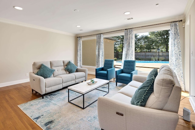 living room with crown molding and hardwood / wood-style flooring