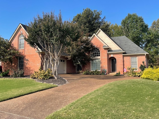 front of property featuring a front yard and a garage