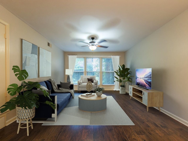 living room with dark wood-type flooring and ceiling fan