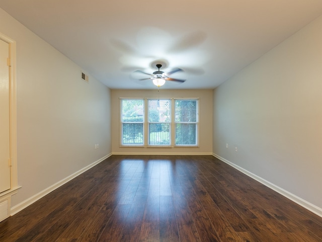 unfurnished room with dark hardwood / wood-style floors and ceiling fan