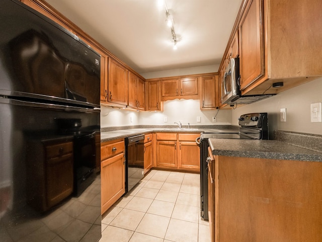 kitchen featuring sink, black appliances, light tile patterned floors, and track lighting