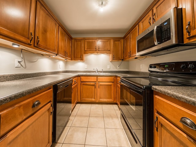 kitchen with sink, black appliances, and light tile patterned floors