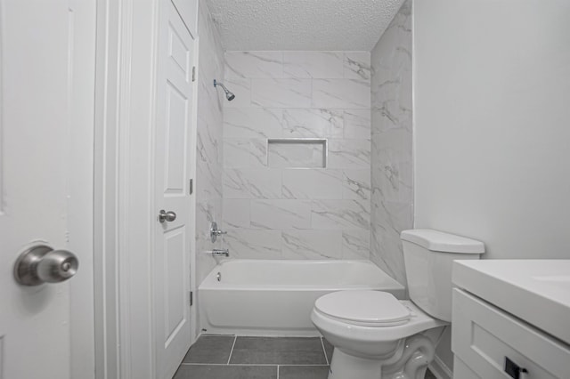 full bathroom featuring a textured ceiling, toilet, vanity, tiled shower / bath combo, and tile patterned floors