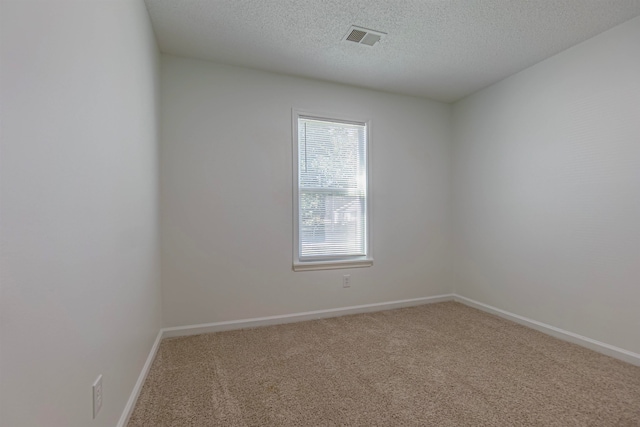 unfurnished room featuring a textured ceiling and carpet floors