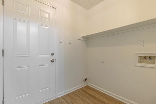 washroom featuring washer hookup, a textured ceiling, hookup for an electric dryer, and hardwood / wood-style floors