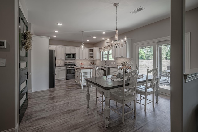 dining area with a notable chandelier and wood-type flooring