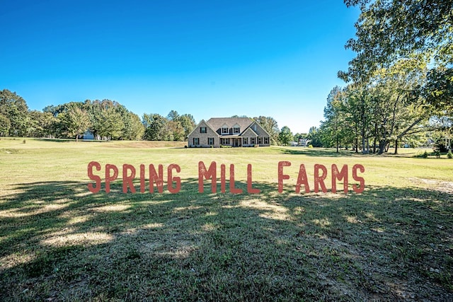 community / neighborhood sign featuring a lawn