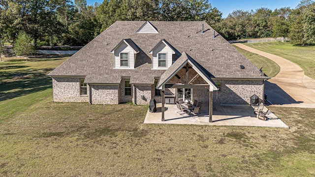 rear view of house featuring a patio and a yard