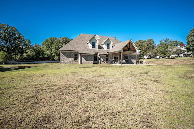 back of property with a patio and a lawn