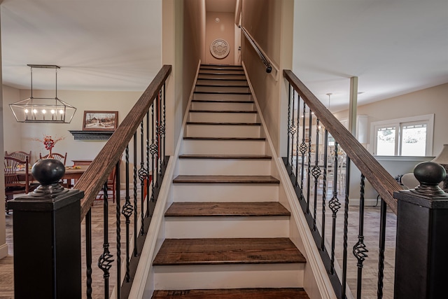 stairway with a chandelier