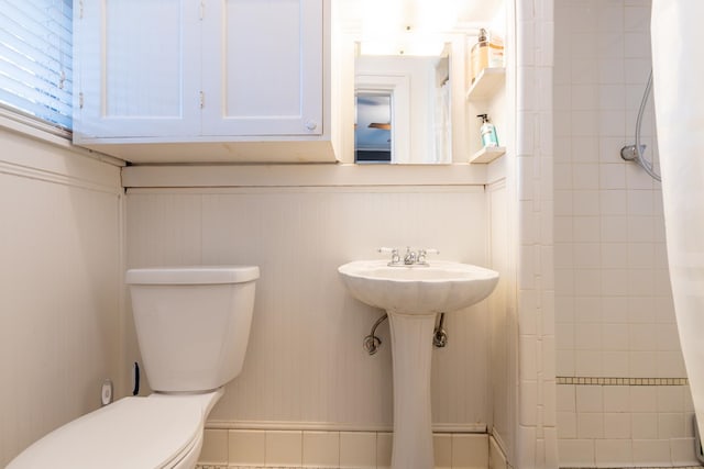 bathroom featuring curtained shower and toilet