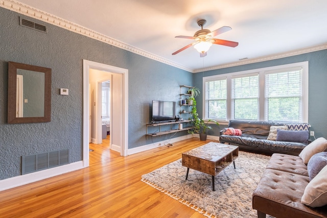 living room with crown molding, hardwood / wood-style flooring, and ceiling fan