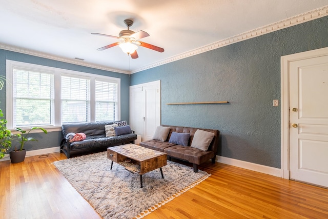 living room with crown molding, hardwood / wood-style flooring, and ceiling fan