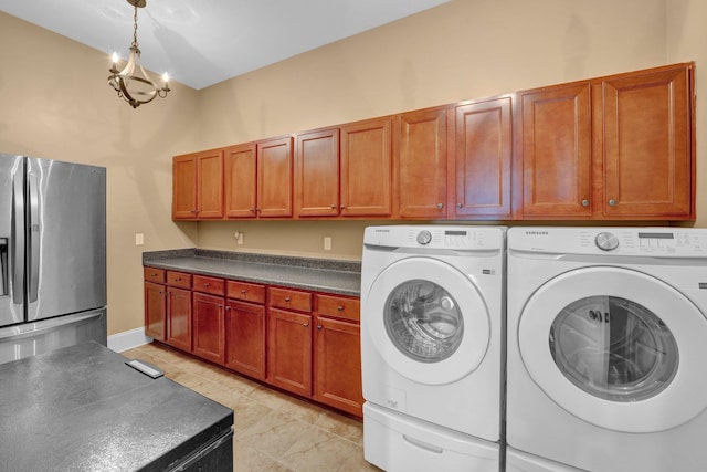 laundry area featuring a chandelier, light tile patterned flooring, and independent washer and dryer