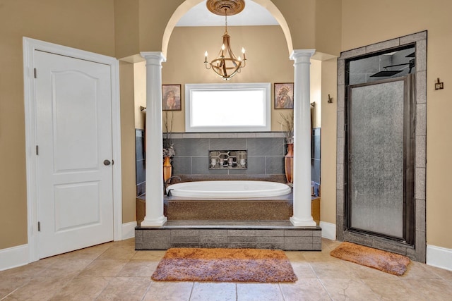 bathroom featuring an inviting chandelier, plus walk in shower, tile patterned floors, and ornate columns