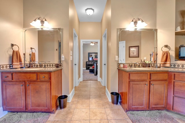 bathroom featuring vanity, a towering ceiling, tile patterned flooring, and ceiling fan