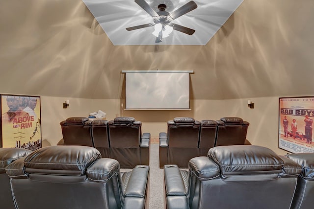 carpeted home theater with ceiling fan and vaulted ceiling