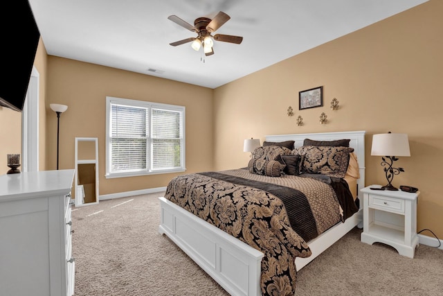 bedroom featuring light colored carpet and ceiling fan