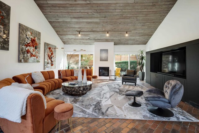 living room with high vaulted ceiling and wooden ceiling