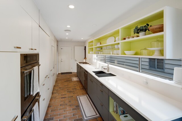 kitchen featuring sink, white cabinets, and stainless steel double oven