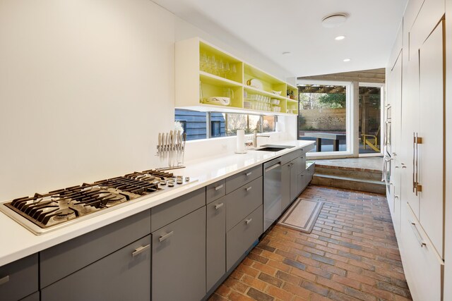 kitchen featuring sink, appliances with stainless steel finishes, and gray cabinetry