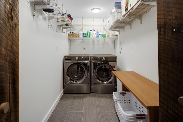 clothes washing area with washing machine and dryer