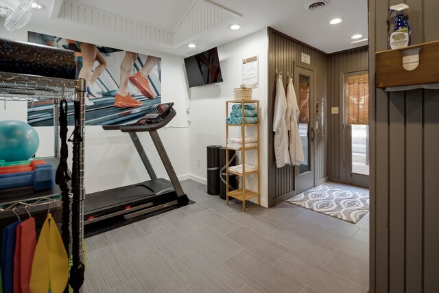 workout area featuring wood walls