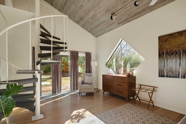 sitting room with rail lighting, high vaulted ceiling, wooden ceiling, and hardwood / wood-style floors